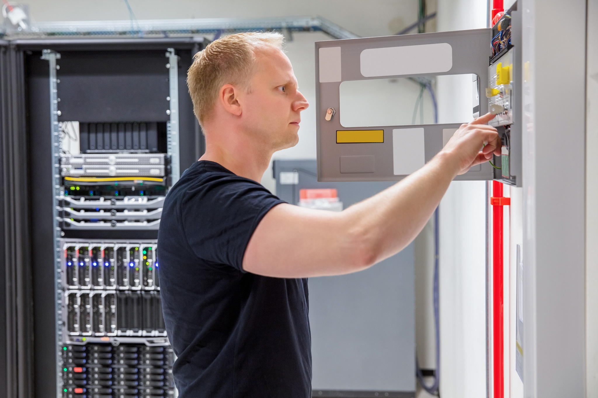 echnician testing fire alarm annunciator panel for compliance.