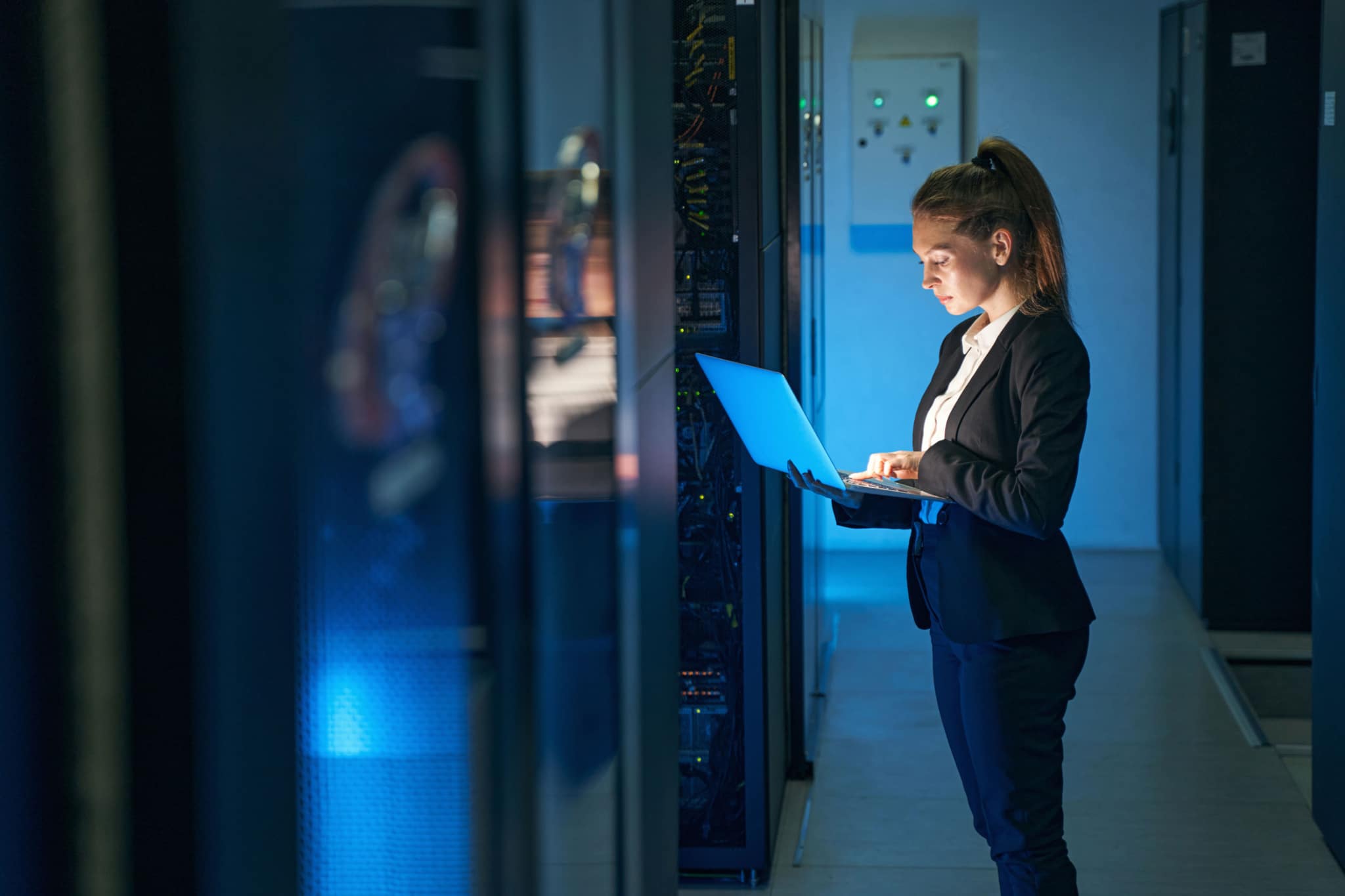 IT professional inspecting a server room